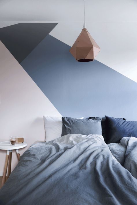 a geometric color block bedroom in blush, navy, black and white and a matching bedding set