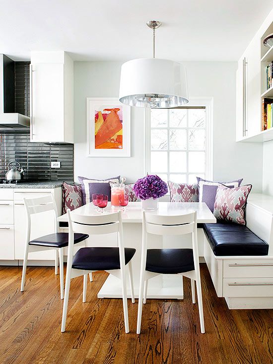 a little lively nook with a corner seating and a square table plus chairs, colorful pillows for a vivacious feel