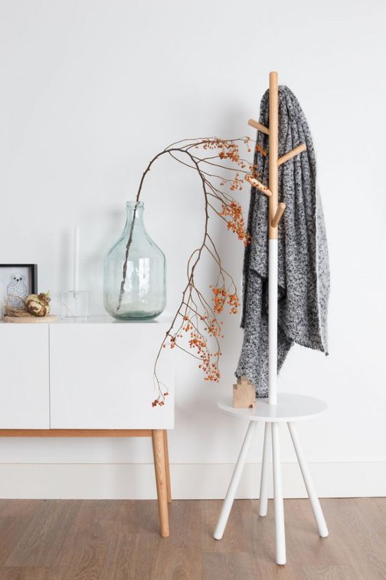 a stylish and simple combo of a coat rack and a little entryway table or seat - as you wish