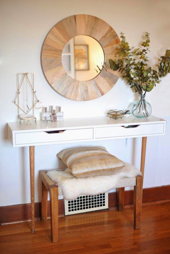 a stylish console made of IKEA items and a stool plus a wood clad mirror over it