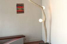 10 a super creative floor lamp with a wood piece base, a tree branch and some bulbs inserted