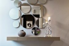 10 an arrangement of round mirrors of various sizes and a floating vanity for an ethereal look