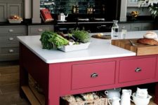 11 a color block effect is achieved in this grey kitchen with a bright pink kitchen island with a white countertop