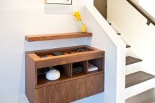 11 a contemporary plywood floating console with a sunken tabletop and a small shelf over the console