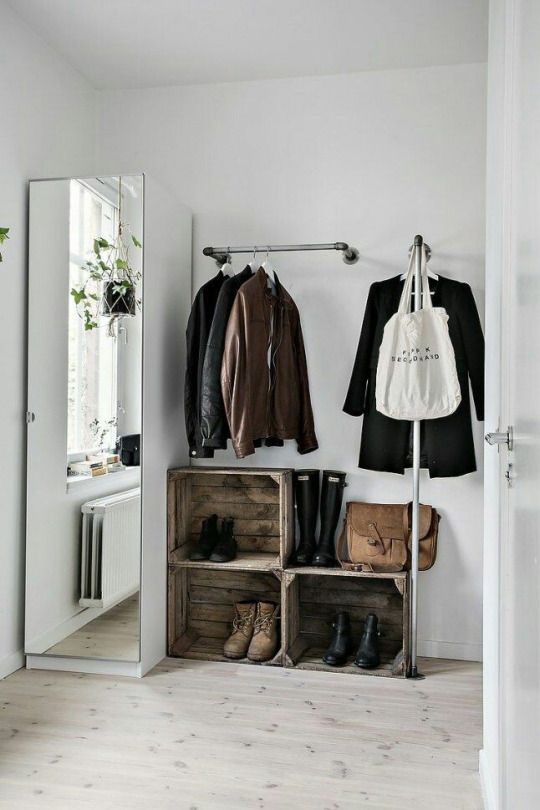 a metal holder for clothes hangers and one more L-shaped coat rack for hanging pieces with style