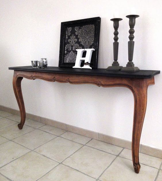 a super elegant console table cut in halves with a black wooden tabletop for a living room