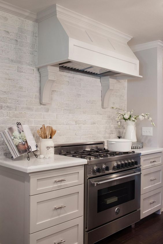 A whitewashed brick backsplash is a cool and chic idea to add texture to your kitchen