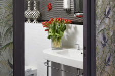 12 The bathroom is done in black and white with catchy patterns and red touches