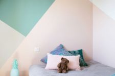 12 a kid’s bedroom is spruced up with color blocking in green, pink, grey and cream, a bold and creative idea