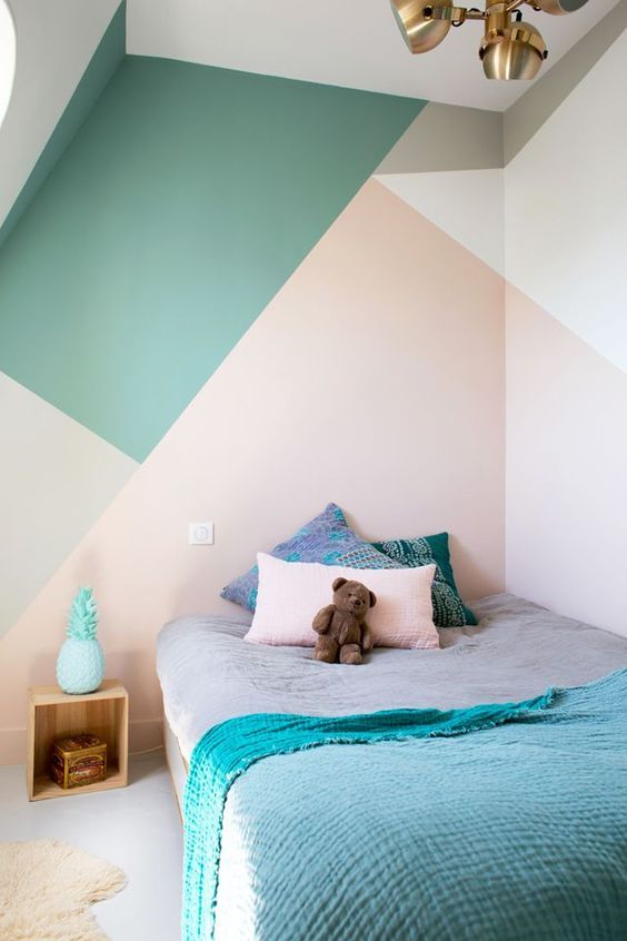 a kid's bedroom is spruced up with color blocking in green, pink, grey and cream, a bold and creative idea