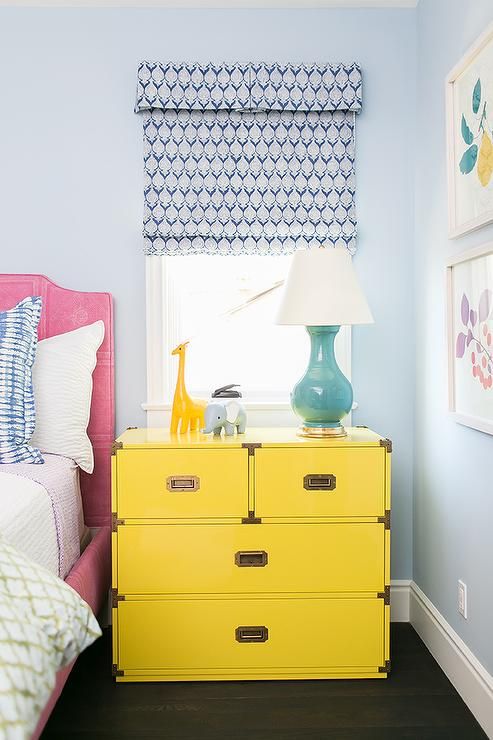 a large and functional dresser nightstand in bold yellow with metallic handles
