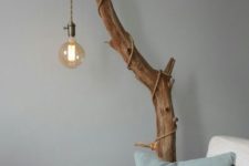 12 cover a stained tree branch with an industrial pendant light with a cord and a large bulb for making a cool lamp