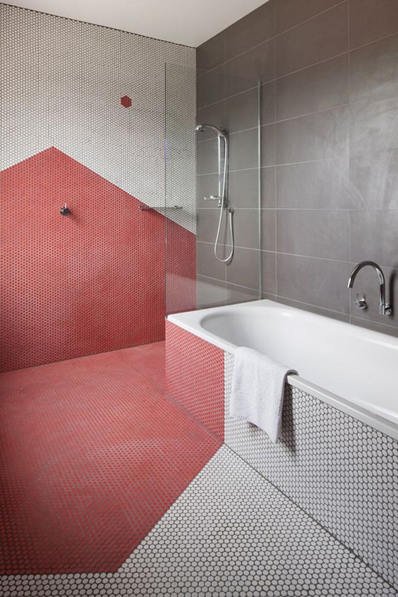 a grey and coral color blocked bathroom with a geometric touch done with penny tiles looks wow