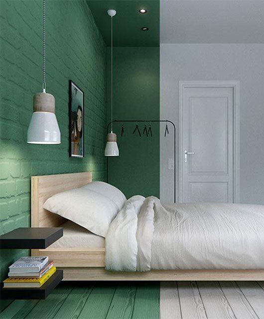 a minimalist bedroom with a sleeping zone accented with bright green color on the walls, ceiling and floor