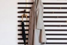 a simple wall-mounted hanger of wooden slabs and hooks attached where necessary – you won’t need more for a small space