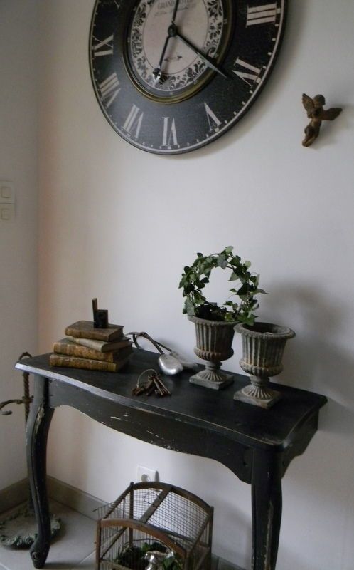 a vintage rustic half console painted black to add a touch of elegance to the space