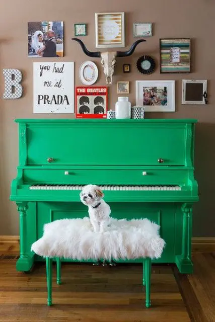 a neon green piano and a faux fur stool plus a gallery wall with bright artworks and photos