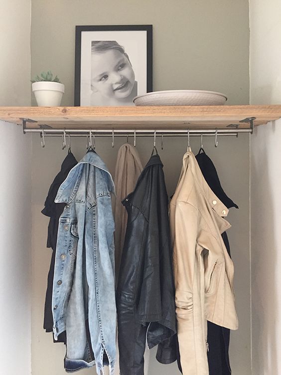 a simple wooden shelf with metal holders and hooks is a simple DIY project to realize