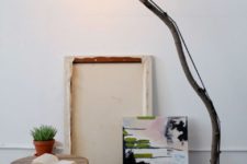 14 such a floor lamp of a long branch, a wood slice base and an industrial bulb can be easily DIYed