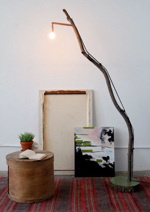 such a floor lamp of a long branch, a wood slice base and an industrial bulb can be easily DIYed