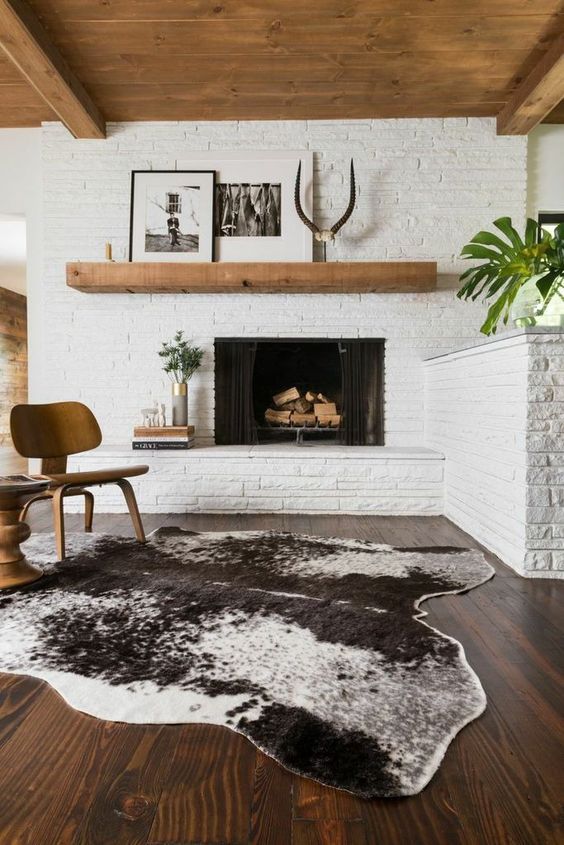 Whitewashed brick walls and a fireplace clad this way for a mid century modern living room