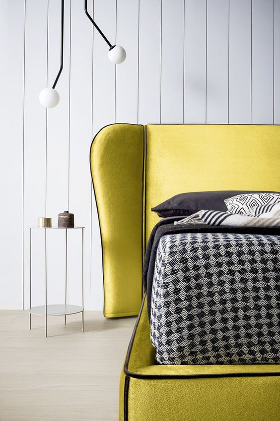 an ultra-modern lemon yellow bed plus dark bedding and pillows for a bright look