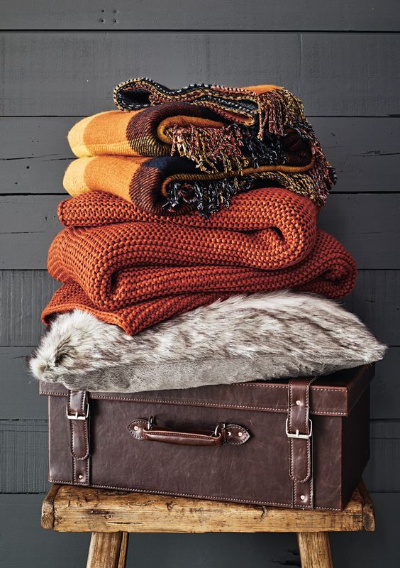 bring colorful blankets and a faux fur throw to your bedroom to add texture and interest plus coziness