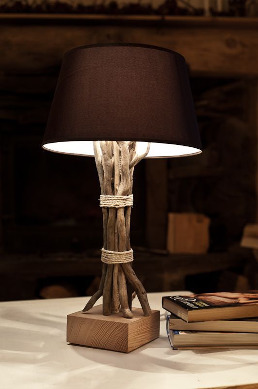 make your usual table lamp natural covering the base with branches and tying it up with simple yarn