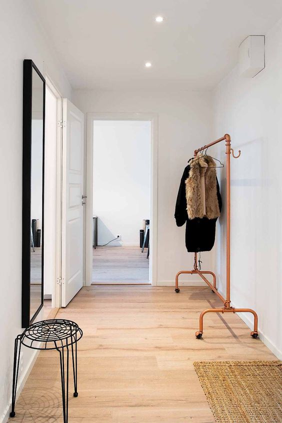 a free-standing coat rack made only of piping is a bright modern solution, and copper is very trendy now
