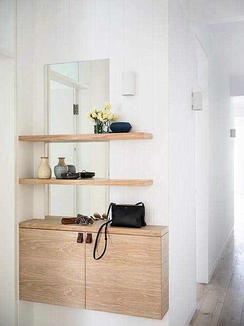 a plywood console and a duo of matching shelves over the console for a comfy contemporary space
