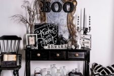 16 a spooky Halloween console in black and white with painted pumpkins and signs plus a vintage mirror