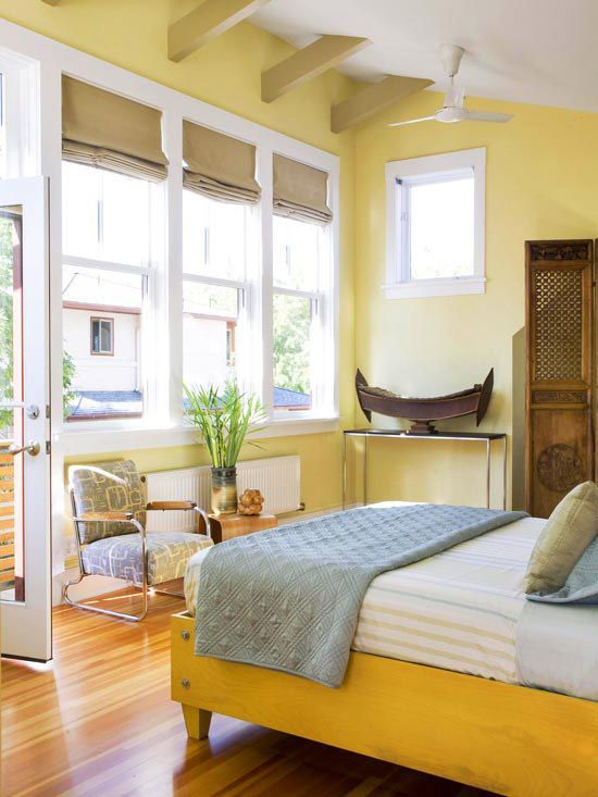 light yellow walls and a bold yellow bed create a look of a room filled with sunlight every day