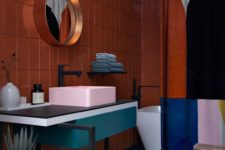 17 a bold color blocked bathroom with a rust wall, a pink sink, a teal vanity and a color blocked shower curtain to match