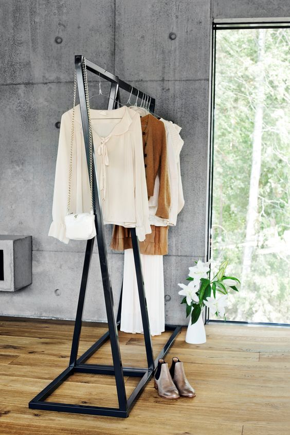 a large blackened metal clothes rack is very stable and can hold a lot of items, you may use it in your closet, too