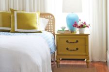 17 a vintage mustard nightstand and matching pillows to add a touch of color