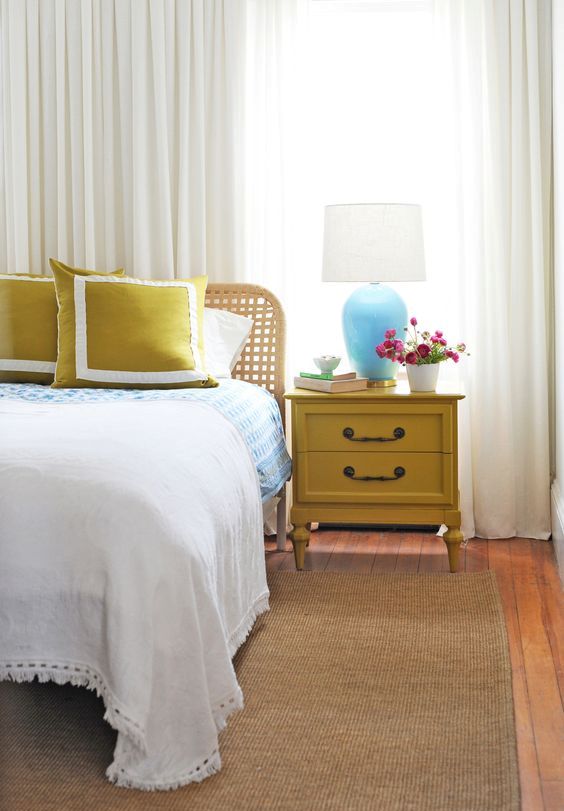 a vintage mustard nightstand and matching pillows to add a touch of color