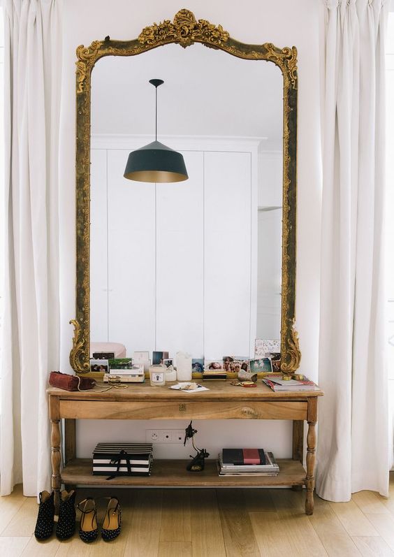 make a statement in a modern space with an oversized vintage mirror with chic detailing