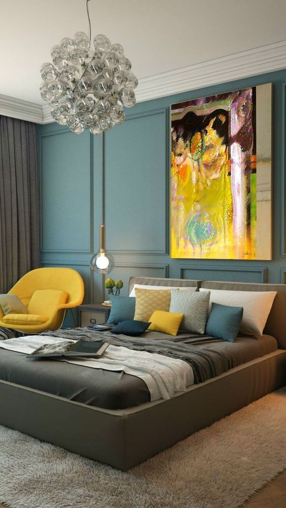 a bright yellow chair, a pillow and a bold artwork with yellow as the main shade for a luxurious bedroom