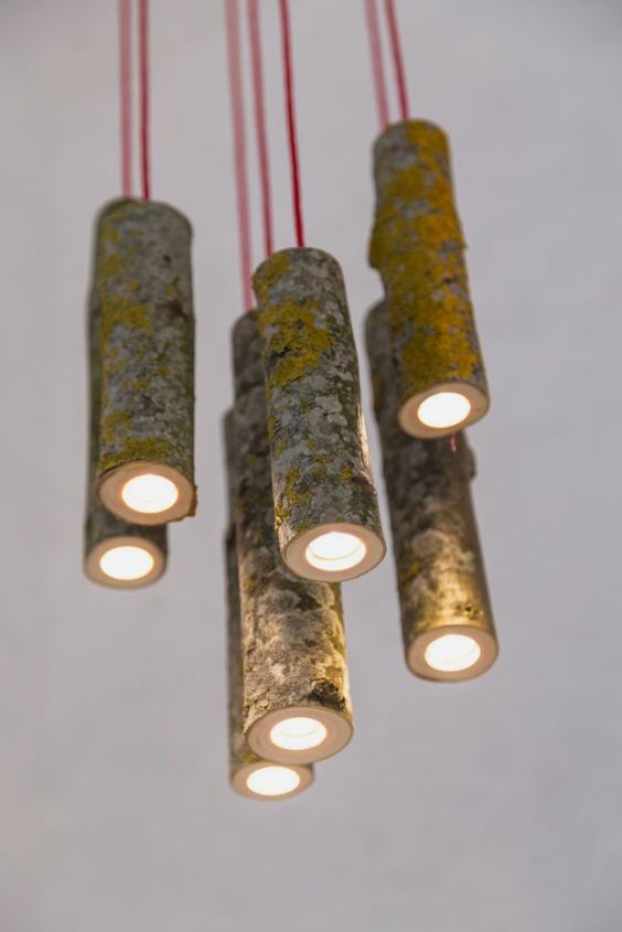 a cluster of awesome pendant lamps made of old tree branches and red cord for a contrasting look