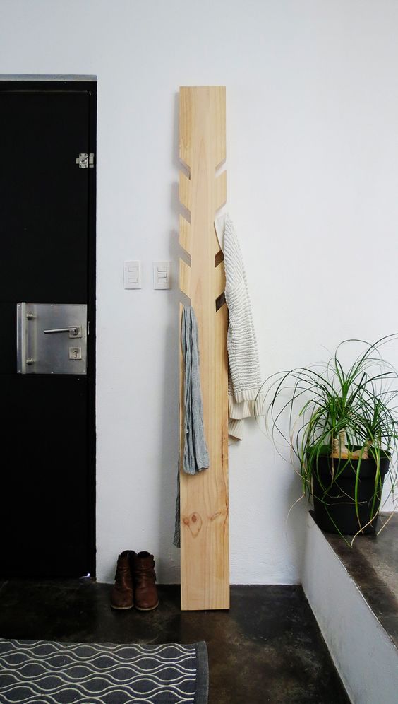 https://i.digsdigs.com/2018/09/18-a-modern-coat-rack-made-of-a-piece-of-wood-with-some-hooks-cut-out-is-a-simple-DIY-project.jpg