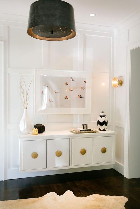 a refined floating console table in white and gold for a luxurious or glam entryway