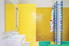 19 a color block upholstered ottoman plus a yellow hexagon tile wall in the shower make the bathroom stand out