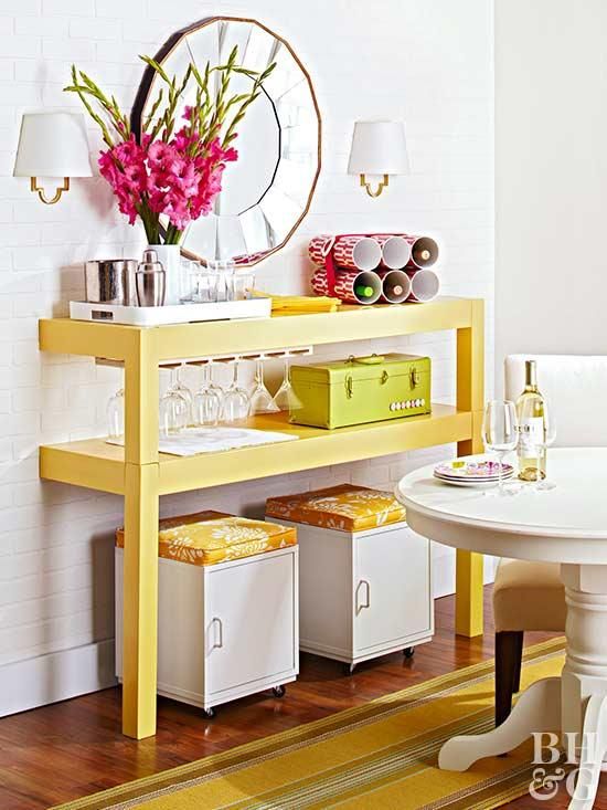 a colorful buffet made of a cut table painted bright yellow, with matchin ottomans