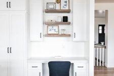 19 a modern farmhouse space with a seamless home office nook with cabinets, built-in shelves and a black chair