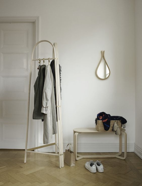 a modern wooden coat rack with three sides and hooks for hanging everything you want