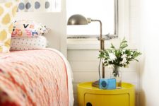 19 an ultra-modern yellow nightstand of a drum shape makes a statement with color