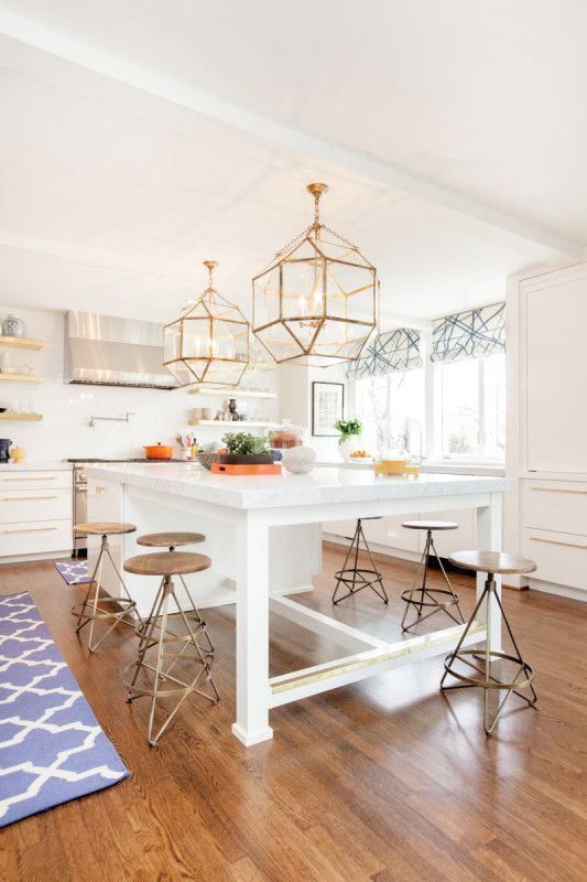 a large white kitchen island that doubles as a dining table and can accommodate many people