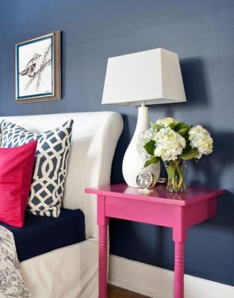 a nightstand made of a cut table and painted hot pink to make a perfect fit for the space