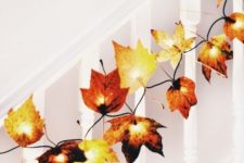 20 add fake leaves to fairy lights to decorate your home for fall, for example, line up the railing of the stairs