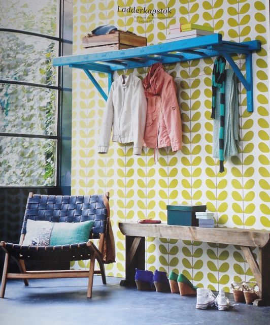 an old ladder painted bright and attached to the wall can serve as a comfortable clothes rack